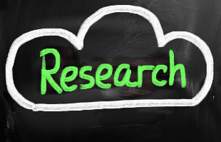word "research" inside a cloud drawn on a blackboard